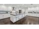 Modern kitchen with a spacious island, bar stools, and stainless steel appliances at 615 E Winter Dr, Phoenix, AZ 85020
