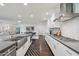 Modern kitchen with a large island, stainless steel sink, and elegant backsplash at 615 E Winter Dr, Phoenix, AZ 85020