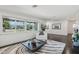 Cozy living room showcasing large windows, hardwood floors, and a comfortable seating arrangement at 615 E Winter Dr, Phoenix, AZ 85020