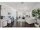 Bright living room with hardwood floors, white furniture, and a modern design aesthetic at 615 E Winter Dr, Phoenix, AZ 85020