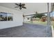 Spacious covered patio features brick pavers, ceiling fans, and views of the lush backyard with a playset at 615 E Winter Dr, Phoenix, AZ 85020