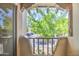 Enchanting balcony with ornate stucco and a view of mature trees and an open parking area at 7300 N Dreamy Draw Dr # 202, Phoenix, AZ 85020
