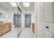 A renovated bathroom with double vanities, skylights, and two enclosed glass showers at 7300 N Dreamy Draw Dr # 202, Phoenix, AZ 85020