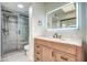 A renovated bathroom vanity with a stylish light-up mirror and modern glass enclosed shower at 7300 N Dreamy Draw Dr # 202, Phoenix, AZ 85020