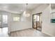 Bright dining space boasts wood-look flooring, modern lighting, and access to outdoor patio at 7300 N Dreamy Draw Dr # 202, Phoenix, AZ 85020