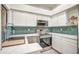 Kitchen featuring stainless steel appliances, sleek countertops, floating shelves, and stylish backsplash at 7300 N Dreamy Draw Dr # 202, Phoenix, AZ 85020