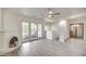 A bright and spacious living room with modern flooring, a ceiling fan, and a unique fireplace design at 7300 N Dreamy Draw Dr # 202, Phoenix, AZ 85020