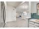 View of the living room and kitchen area featuring a fireplace and white walls at 7300 N Dreamy Draw Dr # 202, Phoenix, AZ 85020