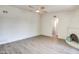 Inviting living room featuring modern flooring, a ceiling fan, and a cozy fireplace nook for a comfortable ambiance at 7300 N Dreamy Draw Dr # 202, Phoenix, AZ 85020