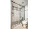 A stylish glass enclosed shower featuring a modern shower head and neutral tiling at 7300 N Dreamy Draw Dr # 202, Phoenix, AZ 85020