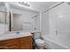 Bathroom with shower and tub combination and wood vanity offers practicality and comfort at 817 E Lamonte St, San Tan Valley, AZ 85140