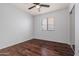 Bedroom with wood floors, ceiling fan, and window offers comfort and style at 817 E Lamonte St, San Tan Valley, AZ 85140