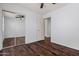 Bedroom features wood floors, ceiling fan, and a mirrored closet at 817 E Lamonte St, San Tan Valley, AZ 85140