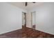 Bedroom features wood floors, a ceiling fan, and a mirrored closet door at 817 E Lamonte St, San Tan Valley, AZ 85140