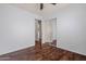Bedroom features wood floors, a ceiling fan, and a mirrored closet door at 817 E Lamonte St, San Tan Valley, AZ 85140