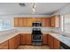 Modern kitchen featuring stainless steel appliances, wood cabinets, and ample counter space at 817 E Lamonte St, San Tan Valley, AZ 85140
