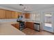 Modern kitchen featuring stainless steel appliances, wood cabinets, and ample counter space at 817 E Lamonte St, San Tan Valley, AZ 85140