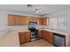 Modern kitchen featuring stainless steel appliances, wood cabinets, and ample counter space at 817 E Lamonte St, San Tan Valley, AZ 85140