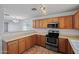 Modern kitchen featuring stainless steel appliances, wood cabinets, and ample counter space at 817 E Lamonte St, San Tan Valley, AZ 85140