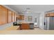 Modern kitchen featuring stainless steel appliances, wood cabinets, and ample counter space at 817 E Lamonte St, San Tan Valley, AZ 85140