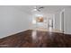 Open-concept living space with hardwood flooring and a seamless flow to the kitchen at 817 E Lamonte St, San Tan Valley, AZ 85140