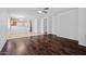 Spacious living room featuring beautiful wood floors, opening to a stylish kitchen with ample lighting at 817 E Lamonte St, San Tan Valley, AZ 85140