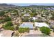 Overhead shot of a desert neighborhood, showcasing mature landscaping and nearby mountain views at 851 E Village Circle N Dr, Phoenix, AZ 85022
