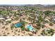 An aerial view of desert homes with a pool and tennis court in a landscaped community setting at 851 E Village Circle N Dr, Phoenix, AZ 85022