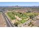 Scenic aerial image of a golf course surrounded by desert landscape and distant mountain peaks at 851 E Village Circle N Dr, Phoenix, AZ 85022