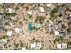 Aerial view of a neighborhood with private pools and tennis court facilities nestled within desert vegetation at 851 E Village Circle N Dr, Phoenix, AZ 85022