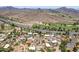 Aerial shot captures homes nestled within a desert landscape, a nearby golf course, and mountain views at 851 E Village Circle N Dr, Phoenix, AZ 85022
