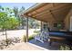 Wide backyard featuring a covered patio with white Adirondack chairs at 851 E Village Circle N Dr, Phoenix, AZ 85022