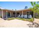 Backyard with desert landscaping, covered patio and sliding glass doors at 851 E Village Circle N Dr, Phoenix, AZ 85022