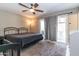 Primary bedroom features a ceiling fan, neutral carpet, and sliding glass doors to an outdoor patio at 851 E Village Circle N Dr, Phoenix, AZ 85022