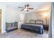 Bedroom with neutral walls and carpet featuring ceiling fan, crib, and double door closet at 851 E Village Circle N Dr, Phoenix, AZ 85022