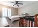 Bedroom featuring neutral carpet, ceiling fan and plantation shutters on the window at 851 E Village Circle N Dr, Phoenix, AZ 85022