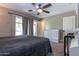 Primary bedroom features ceiling fan, neutral carpet, large dresser and sliding glass doors to patio at 851 E Village Circle N Dr, Phoenix, AZ 85022
