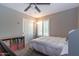 Bedroom featuring neutral carpet, ceiling fan and plantation shutters on the window at 851 E Village Circle N Dr, Phoenix, AZ 85022