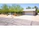 A single-story home featuring drought-resistant landscaping, a walkway, and two car garage at 851 E Village Circle N Dr, Phoenix, AZ 85022