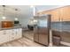 Updated kitchen with stainless steel refrigerator and a view into the dining area at 851 E Village Circle N Dr, Phoenix, AZ 85022