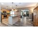 Open kitchen with a center island, stainless steel appliances, and wood-look tile flooring at 851 E Village Circle N Dr, Phoenix, AZ 85022