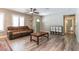 Inviting living room with wood-look tile flooring, ceiling fan, and an exterior door at 851 E Village Circle N Dr, Phoenix, AZ 85022