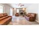 Spacious living room with multiple seating options, a fireplace, and wood-look tile flooring at 851 E Village Circle N Dr, Phoenix, AZ 85022