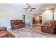 Bright living room with ceiling fan features wood-look floors and doorway leading to dining area at 851 E Village Circle N Dr, Phoenix, AZ 85022