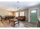 Bright living room with an exterior door, wood-look tile flooring, and an open dining area at 851 E Village Circle N Dr, Phoenix, AZ 85022