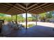 Covered patio with wood beamed ceiling and four white Adirondack chairs at 851 E Village Circle N Dr, Phoenix, AZ 85022