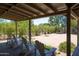 Rear covered patio features wood beamed ceiling and white Adirondack chairs at 851 E Village Circle N Dr, Phoenix, AZ 85022