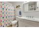 Bathroom features a shower with colorful curtain, a white vanity, and mirror at 856 N Evergreen St, Chandler, AZ 85225