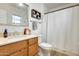 This bathroom has a wood vanity, modern fixtures, and shower with curtain at 856 N Evergreen St, Chandler, AZ 85225