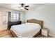 This bedroom has wood floors, a ceiling fan, and a big window at 856 N Evergreen St, Chandler, AZ 85225
